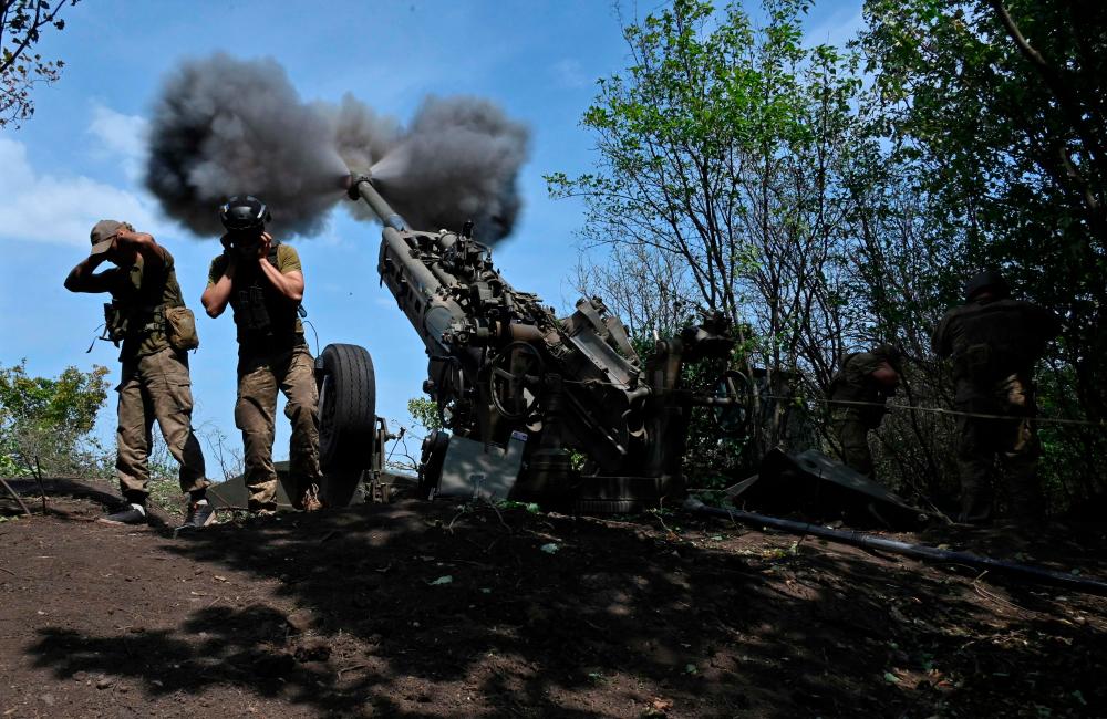 Ukrainian gunmen fire a US made M777 howitzer from their position on the front line in Kharkiv region on August 1, 2022, amid Russia’s military invasion launched on Ukraine. AFPPIX