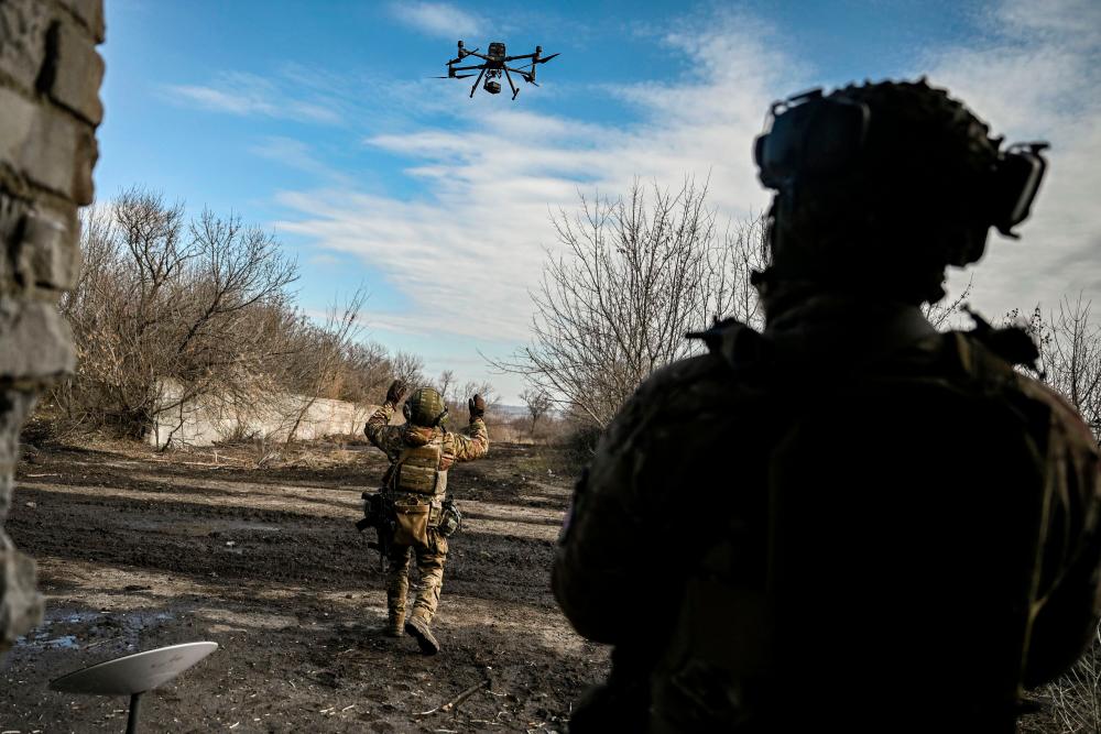 A Ukrainian serviceman flies a drone to spot Russian positions near the city of Bakhmut, in the region of Donbas, on March 5, 2023. AFPPIX