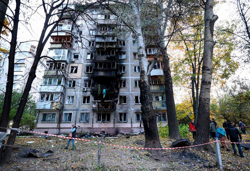 Local residents walk around their multi-story building damaged by the explosion of a drone strike in Kyiv - AFPpix