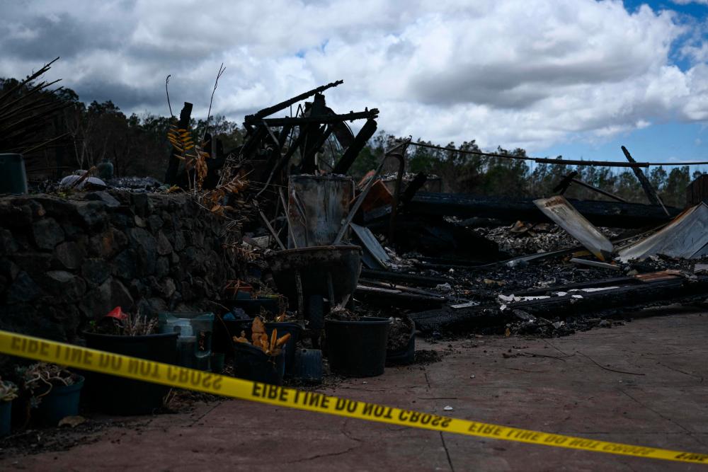 Police tape surrounds the site of a home destroyed by the Maui wildfires in Kula, Hawaii on August 13, 2023. AFPPIX