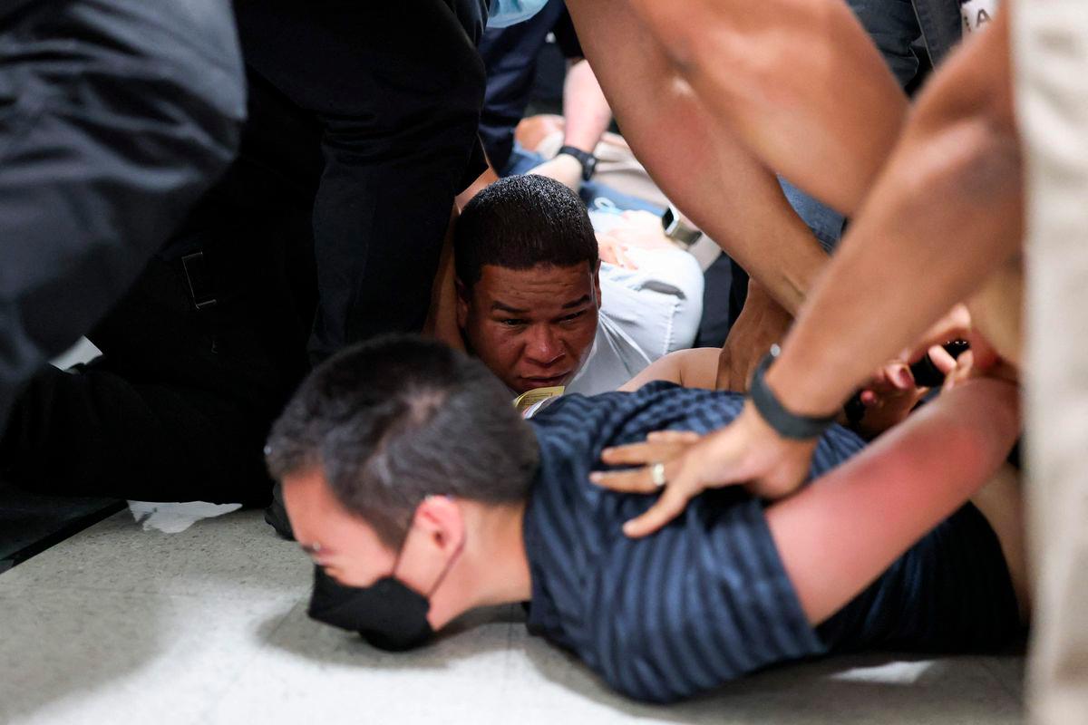 Joaquin Rosario (in white shirt), 34, from the Dominican Republic, is detained by plainclothes officers with Immigration and Customs Enforcement (ICE) after his court hearing in a hallway outside of a courtroom at New York-Federal Plaza Immigration Court inside the Jacob K. Javitz Federal Building in New York City on June 6, 2025. - AFPPIX