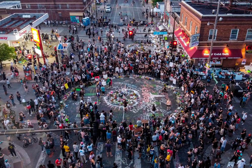 Ariel view of protestors gathered near the makeshift memorial in honour of George Floyd marking one week anniversary of his death, on June 1, 2020 in Minneapolis, Minnesota. Major US cities - convulsed by protests, clashes with police and looting since the death in Minneapolis police custody of George Floyd a week ago - braced Monday for another night of unrest. More than 40 cities have imposed curfews after consecutive nights of tension that included looting and the trashing of parked cars. - AFP