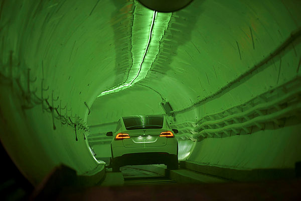 A modified Tesla Model X drives into the tunnel entrance before an unveiling event for the Boring Co. Hawthorne test tunnel in Hawthorne, south of Los Angeles on Dec 18, 2018. — AFP