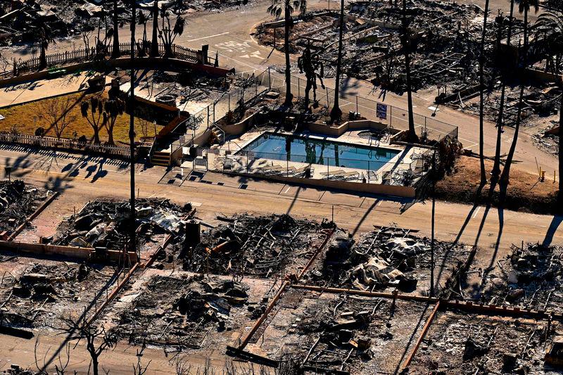 A swimming pool sits amid charred homes and burnt cars in the rubble of the fire-ravaged Pacific Palisades Bowl Mobile Estates in Los Angeles, California, on January 13, 2025. AFPPIX