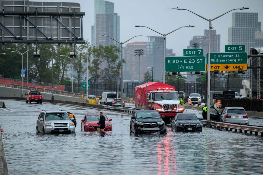 Cars in floodwater on the FDR highway in Manhattan, New York on September 29, 2023. AFPPIX