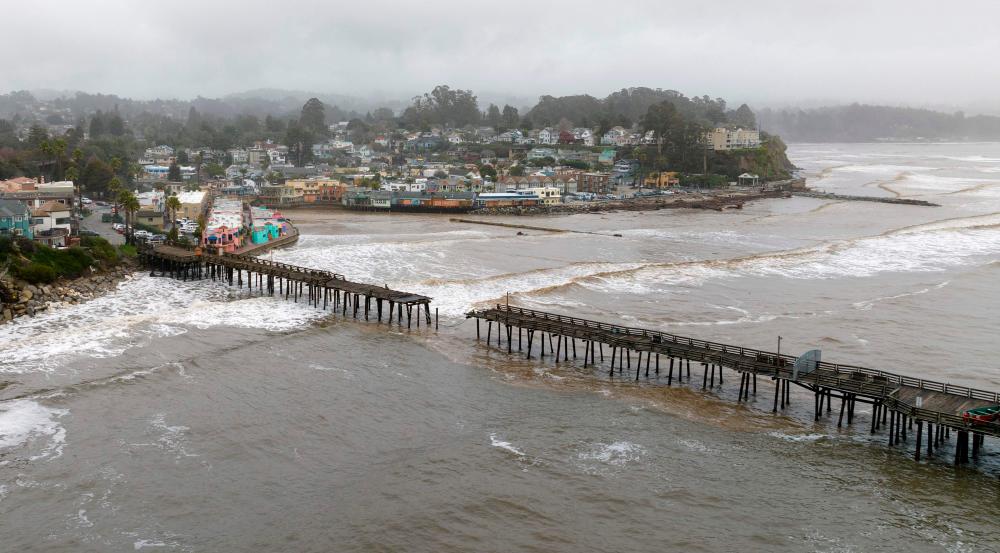 This aerial view shows a damaged pier is split in Capitola, California, on January 9, 2023. A massive storm called a “bomb cyclone” by meteorologists has arrived and is expected to cause widespread flooding throughout the state/AFPPix