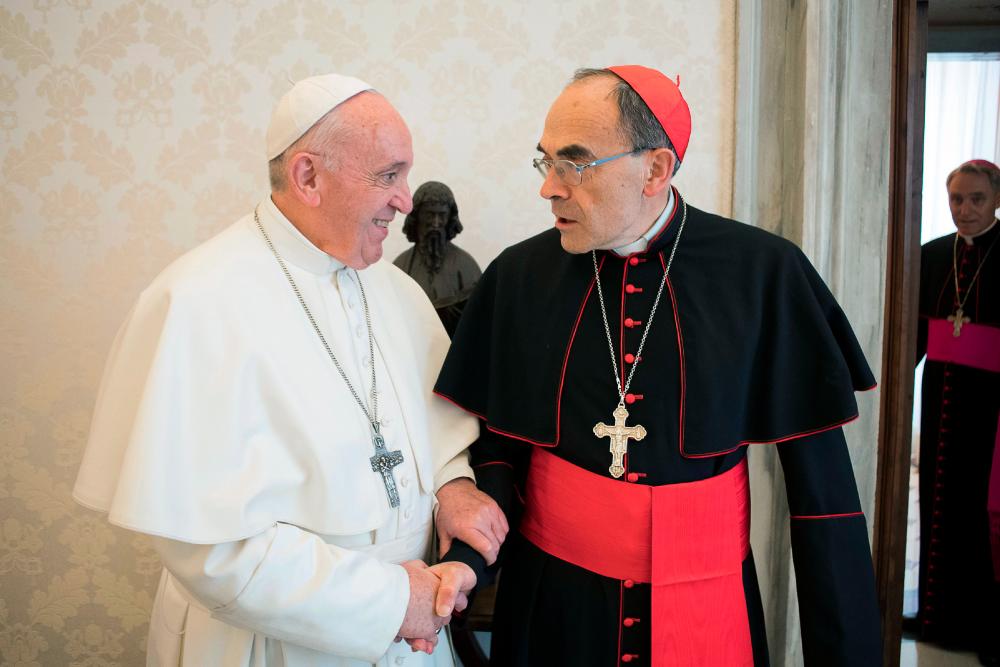 This handout photo taken and released on March 18, 2019 by the Vatican press office, the Vatican Media, shows Pope Francis shaking hands with France's Cardinal Philippe Barbarin (R), during their meeting at the Vatican on March 18, 2019. — AFP