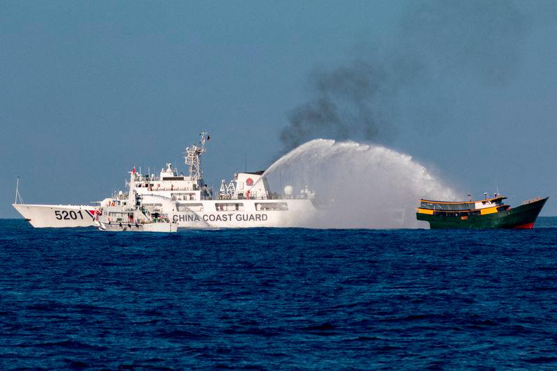 Chinese Coast Guard vessels fire water cannons towards a Philippine resupply vessel Unaizah May 4 on its way to a resupply mission at Second Thomas Shoal in the South China Sea - REUTERSpix