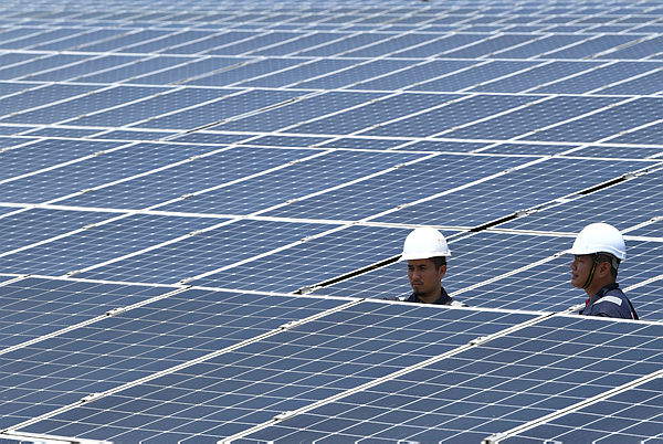 Operations specialist inspect solar panels at the Solar Energy Plant in Machang on Oct 10 — Bernama