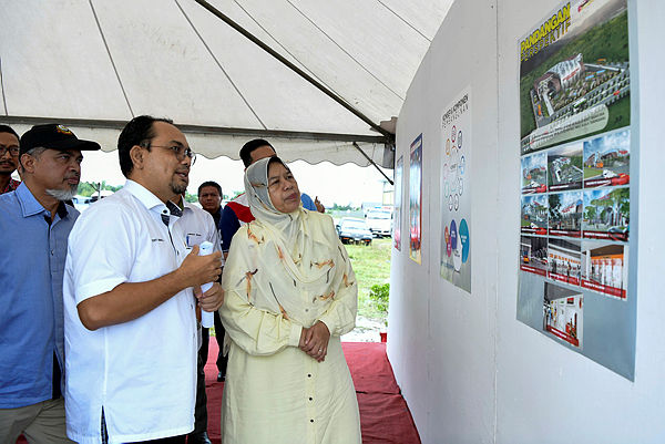 Housing and Local Government Minister Zuraida Kamaruddin looks at plans for the construction of the integrated transport terminal, during a visit to the project site near Bandar Baru Bukit Besar in Terengganu. — Bernama
