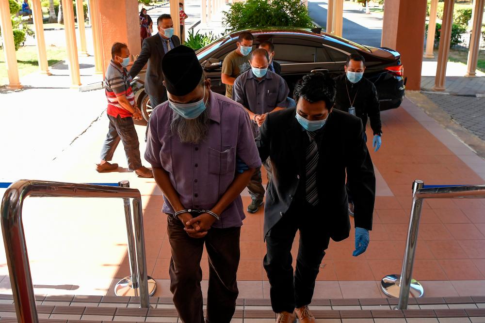 A former director of a research institute (left) and three other men, who were managers of a supplier company has been remanded for six days starting today by the Magistrate’s Court here on suspicion of making false claims worth nearly RM70,000. — Bernama