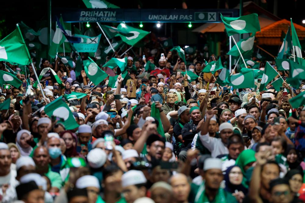 MARANG, Nov 19 -- PAS supporters celebrate the victory of P037 Marang Parliamentary candidate who is also PAS President Tan Sri Abdul Hadi Awang, winning with a majority of 41,729 votes while witnessing the results of the 15th General Election (GE15) in Rusila tonight. BERNAMAPIX
