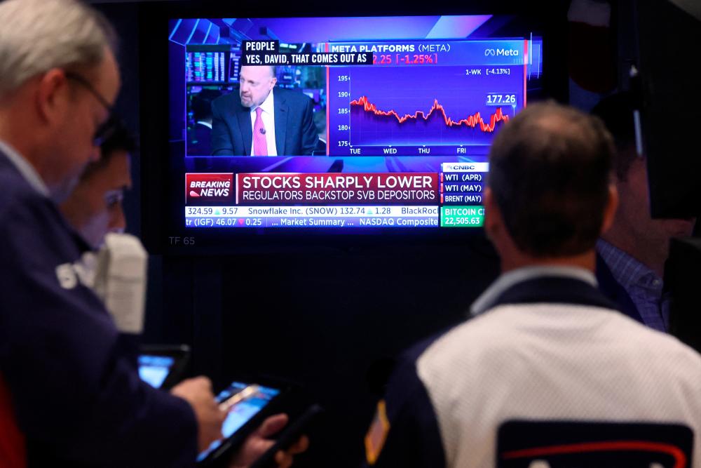 Traders working on the floor of the New York Stock Exchange on Monday, March 13, 2023. – Reuterspic
