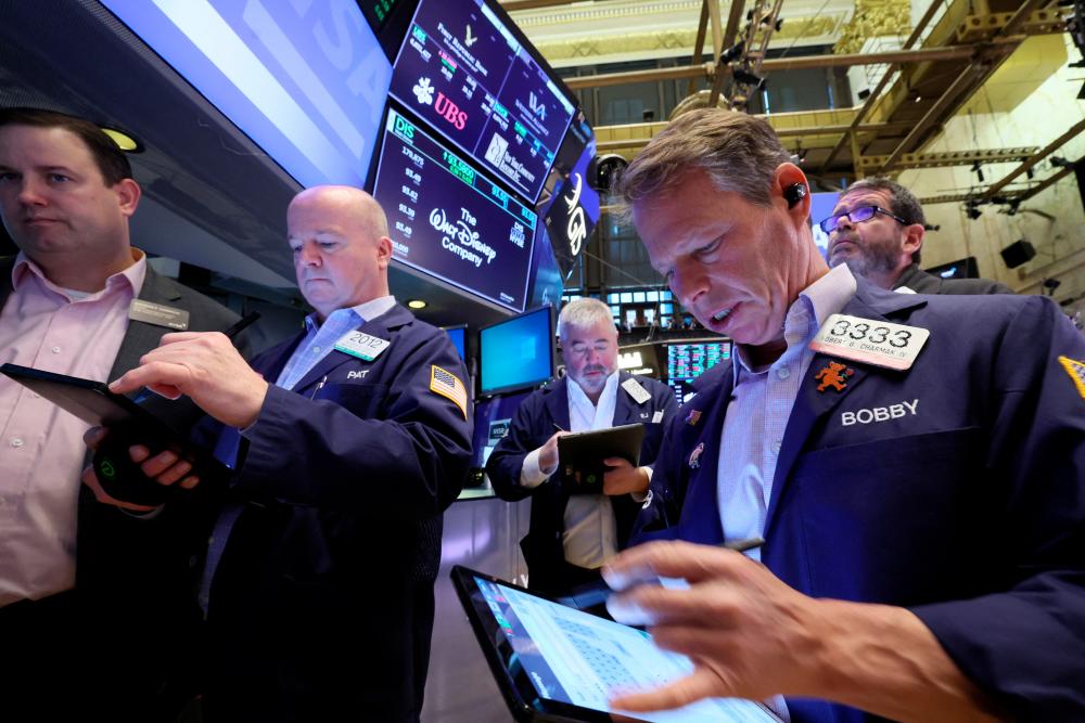 Traders working on the floor of the New York Stock Exchange on Monday, March 20, 2023. – Reuterspic