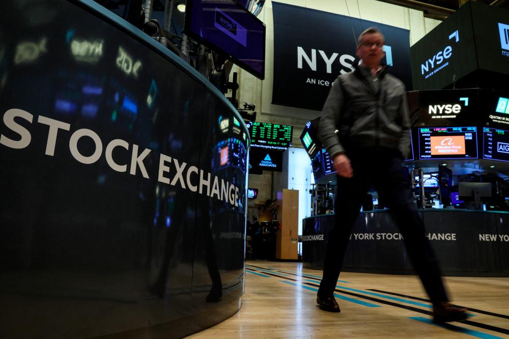 A trader is seen on the floor of the New York Stock Exchange on Thursday, March 30, 2023. – Reuterspic