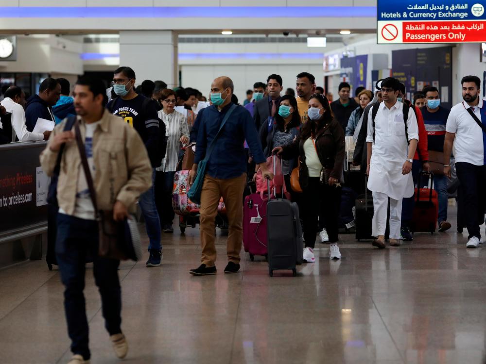 Travellers wear masks as they arrive at the Dubai International Airport, after the UAE's Ministry of Health and Community Prevention confirmed the country's first case of coronavirus, in Dubai, United Arab Emirates January 29, 2020. - Reuters