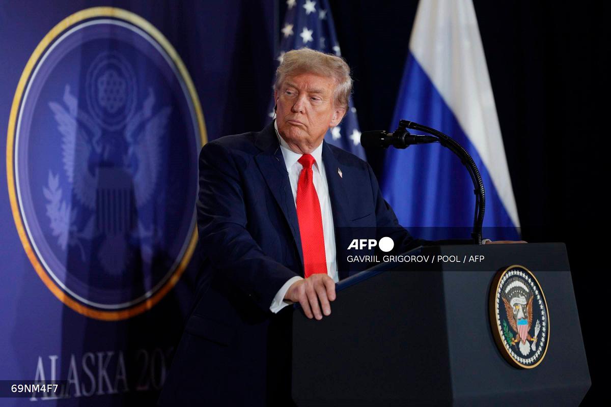 In this pool photograph distributed by the Russian state agency Sputnik, US President Donald Trump listens to Russian President Vladimir Putin during a joint press conference after participating in a US-Russia summit on Ukraine at Joint Base Elmendorf-Richardson in Anchorage, Alaska, on August 15, 2025. - Gavriil GRIGOROV / POOL / AFP
