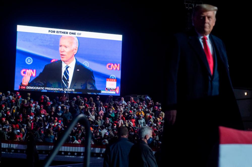 US President Donald Trump watches a video of Democratic presidential nominee former Vice President Joe Biden as he holds a Make America Great Again rally as he campaigns at Erie International Airport in Erie, Pennsylvania, October 20, 2020. — AFP