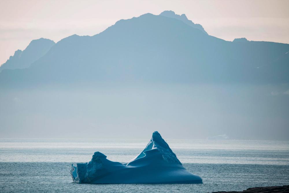 An iceberg floats near Kulusuk island in Greenland on August 20, 2019. Denmark's prime minister said on August, 21, 2019 she was annoyed and surprised that US President Donald Trump postponed a visit after her government said its territory Greenland was not for sale, but insisted their ties remained strong. - AFP