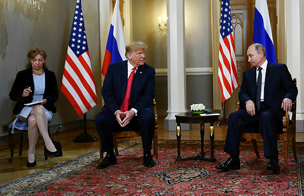 Russian President Vladimir Putin (R) and US President Donald Trump (2L) attend a meeting in Helsinki, on July 16, 2018. — AFP