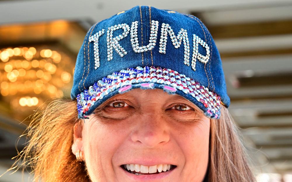 A supporter of Donald Trump wears a bedazzled hat upon leaving Trump International Hotel in Las Vegas, Nevada, on Wednesday. Trump has made it clear that he will introduce tariffs and taxes that will bring manufacturing back to the US. – AFPpic