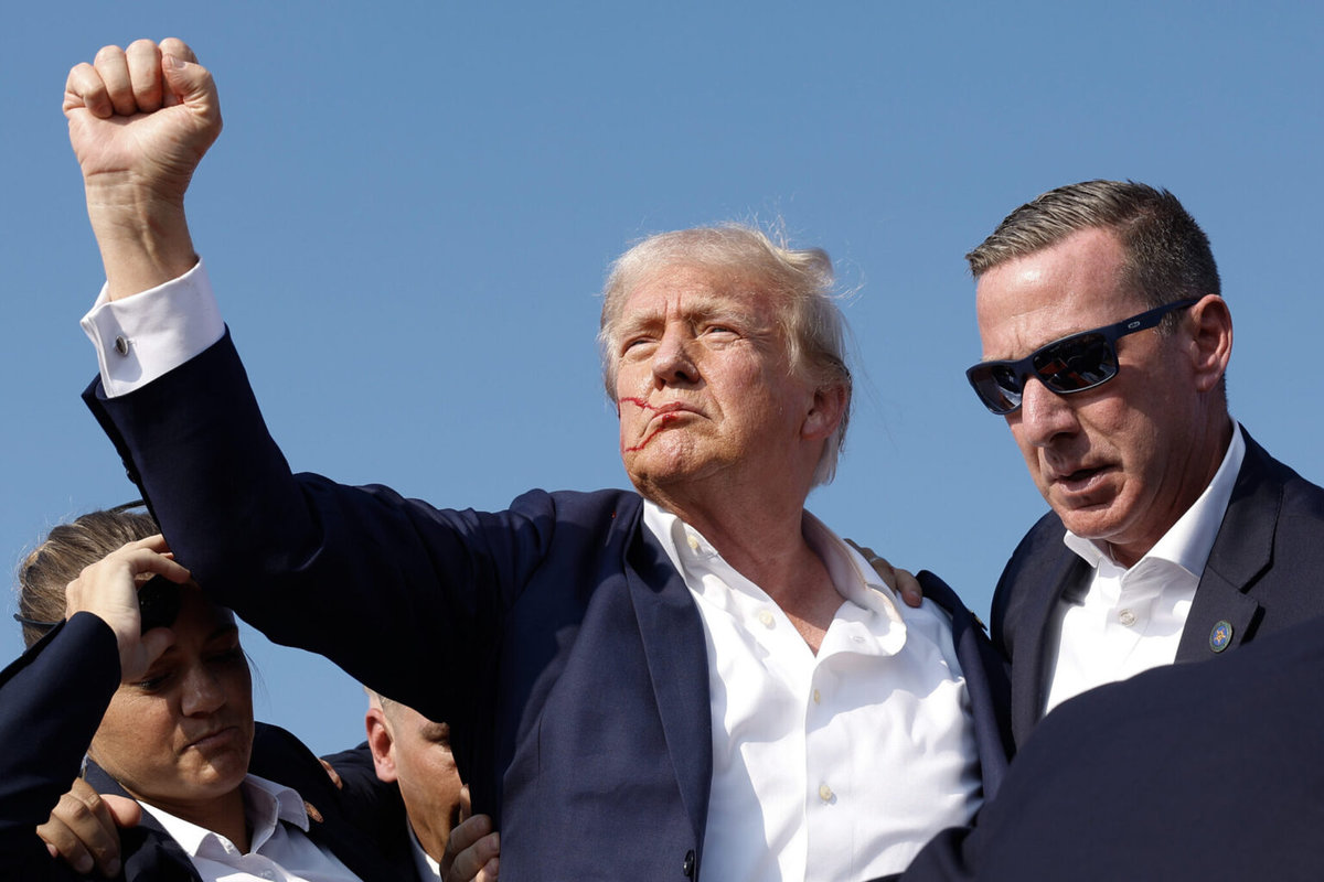 Republican presidential candidate former President Donald Trump pumps his fist as he is rushed offstage during a rally on July 13, 2024 in Butler, Pennsylvania. - Getty Images