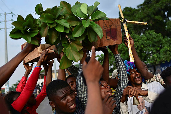 Supporters of Martin Fayulu, the runner up in the Democratic Republic of the Congo’s(DRC’S) elections, carry a mock coffin bearing the slogan “Good Bye Felix” as they protest in the streets of Kinshasa — AFP