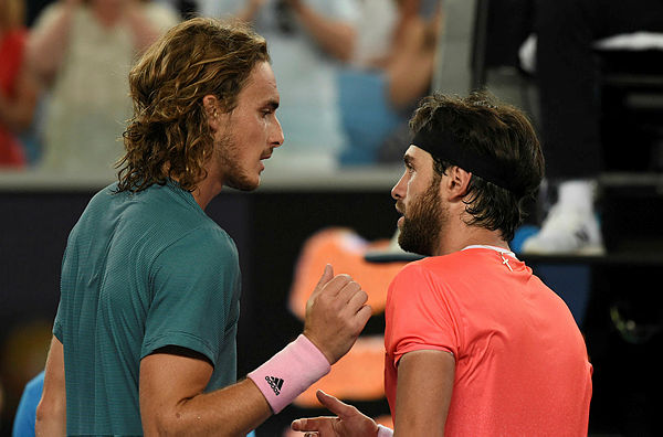 Greece’s Stefanos Tsitsipas (L) shakes hand with Georgia’s Nikoloz Basilashvili after their men’s singles match on day five of the Australian Open. — AFP