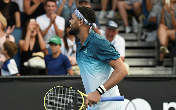 France’s Jo-Wilfried Tsonga celebrates after victory over Slovakia’s Martin Klizan during their men’s singles match on day two of the Australian Open tennis tournament in Melbourne — AFP