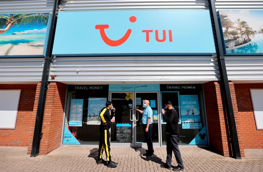 People outside the TUI travel centre in Hanley, Stoke-on-Trent, Britain, in July. – REUTERSPIX