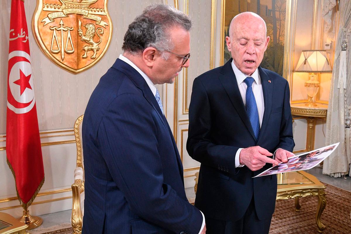 This handout picture provided by the Tunisian Presidency's Press Service shows Tunisia's President Kais Saied (R) showing Massad Boulos, senior adviser to the US president for Africa, pictures of starving children in Gaza during their meeting at the presidential palace in Carthage on July 22, 2025. - AFP PHOTO / HO / PRESIDENCY PRESS SERVICE