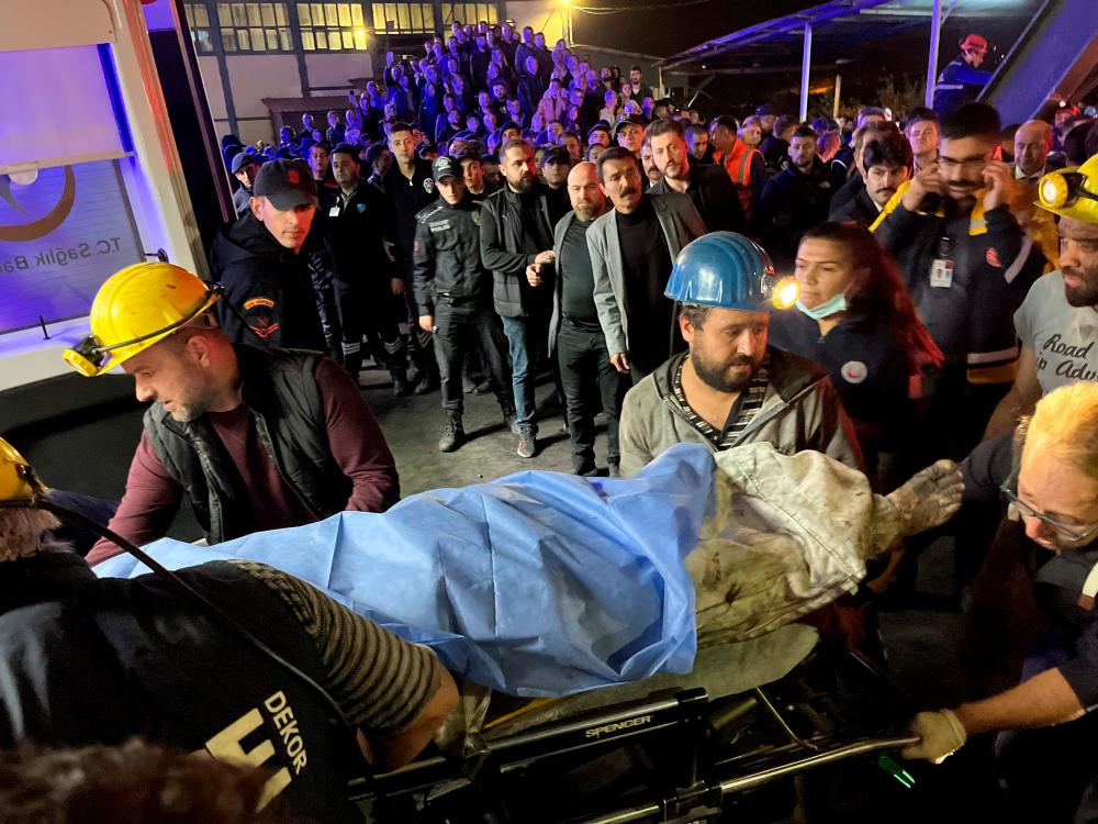 An injured or death miner is carried by rescuers after an explosion at a coal mine in Bartin, northern Turkey, on October 14 2022. AFPPIX