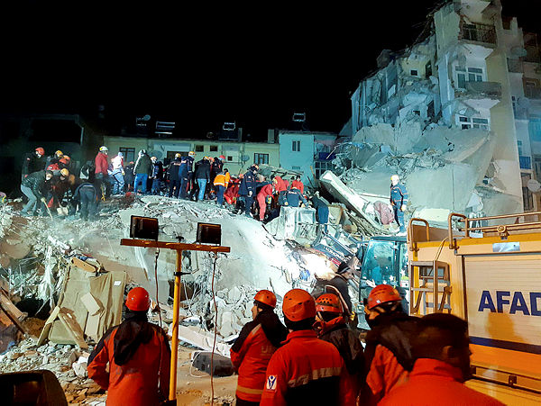 Turkish officials and police work at the scene of a collapsed building following a 6.8 magnitude earthquake in Elazig, eastern Turkey on Jan 25. — AFP