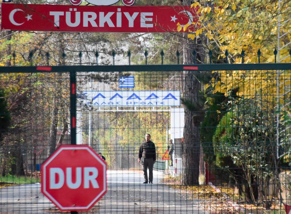 A man (C), allegedly a US citizen and a member of the Islamic State group (IS), who was deported by Turkish officials and rejected by Greek police, standing in a no man's land at the border between Turkey and Greece near Pazarkule, is seen from the Turkish side in Edirne, on Nov 11. — AFP