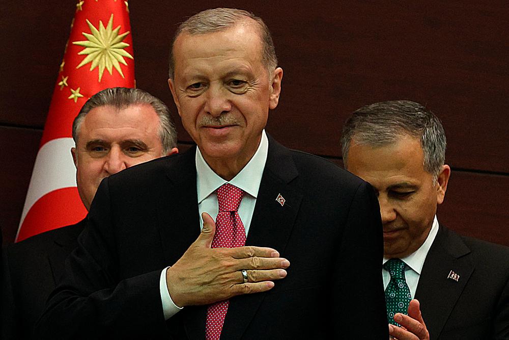 Turkey’s President Recep Tayyip Erdogan (C) gestures next to Turkey’s new Interior Minister Ali Yerlikaya (R) as he unveils the country’s new cabinet at Cankaya Palace after he was sworn in as President in Parliament in Ankara on June 3, 2023/AFPPix