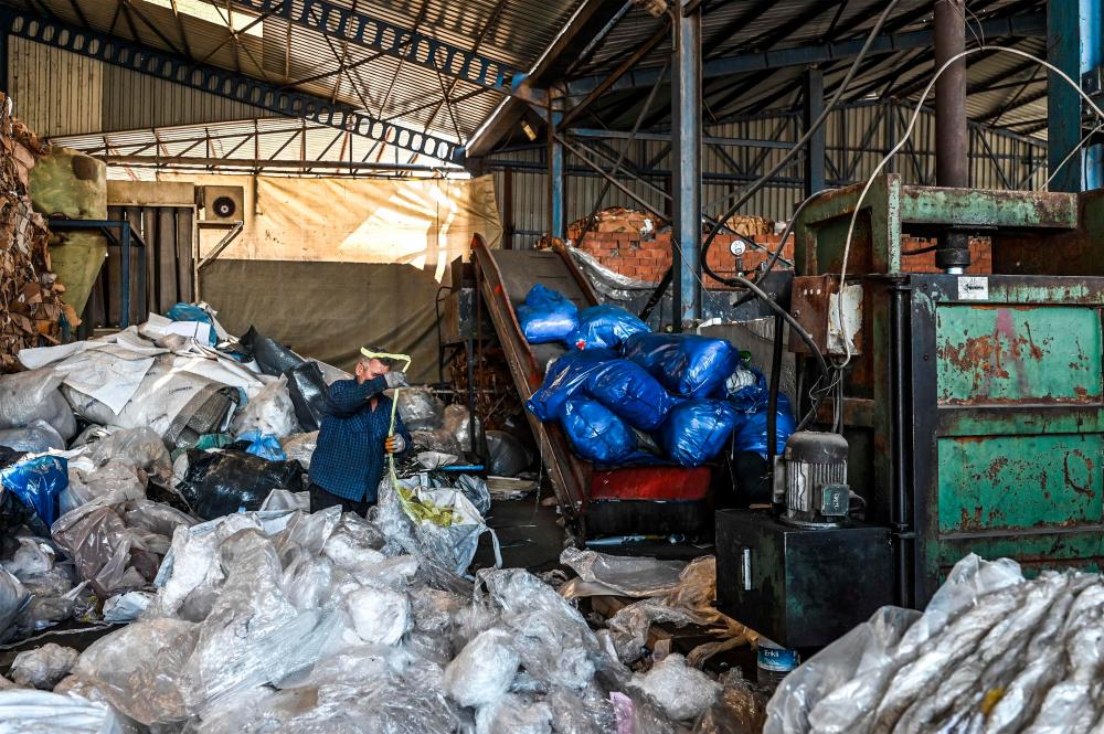 A worker sorts out plastic waste collected at a plastic recycling factory in Kartepe, district of Kocaelion, May 11, 2022. AFPPIX