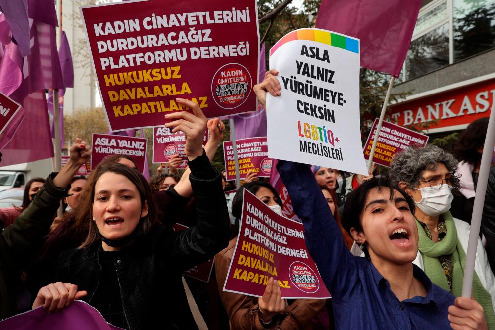 Women hold up banners and shout slogans as they protest against the closure case filed against the ‘We Will Stop Femicide Platform Association’ in Ankara on April 16, 2022. AFPPIX