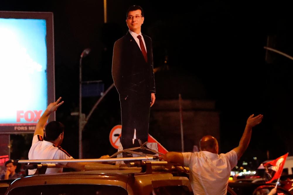 A cardboard silhouette representing Ekrem Imamoglu, of the secular opposition Republican People’s Party (CHP), is seen on a car as people celebrate after Imamoglu won Istanbul’s re-run mayoral elections, in Istanbul on June 23, 2019. — AFP