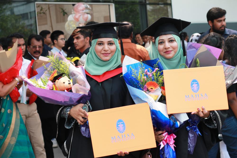 Twins celebrating their graduation.