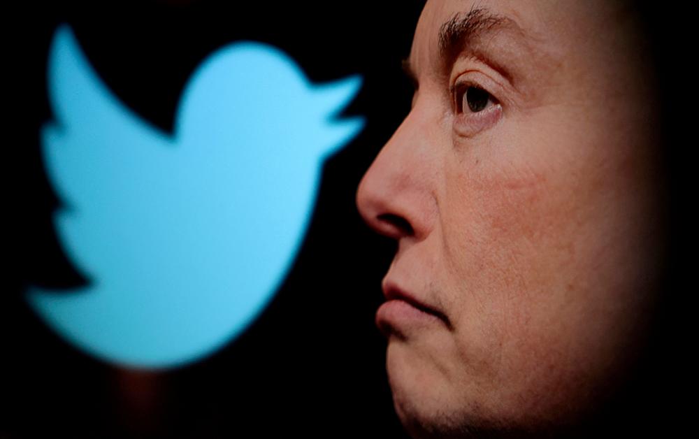 Twitter’s logo and a photo of Musk are displayed through a magnifier in this illustration. – Reuterspic