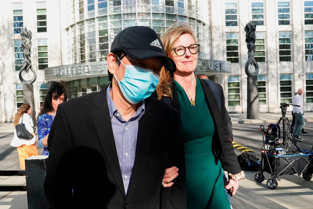 Lu Jianwang, 61, a US citizen charged with conspiring to act as an agent of the Chinese government by helping set up a Chinese ‘secret police station’ in New York, and his attorney Deidre von Dornum exit Brooklyn federal court after Lu posted bond in New York April 17, 2023. ― Reuters pic