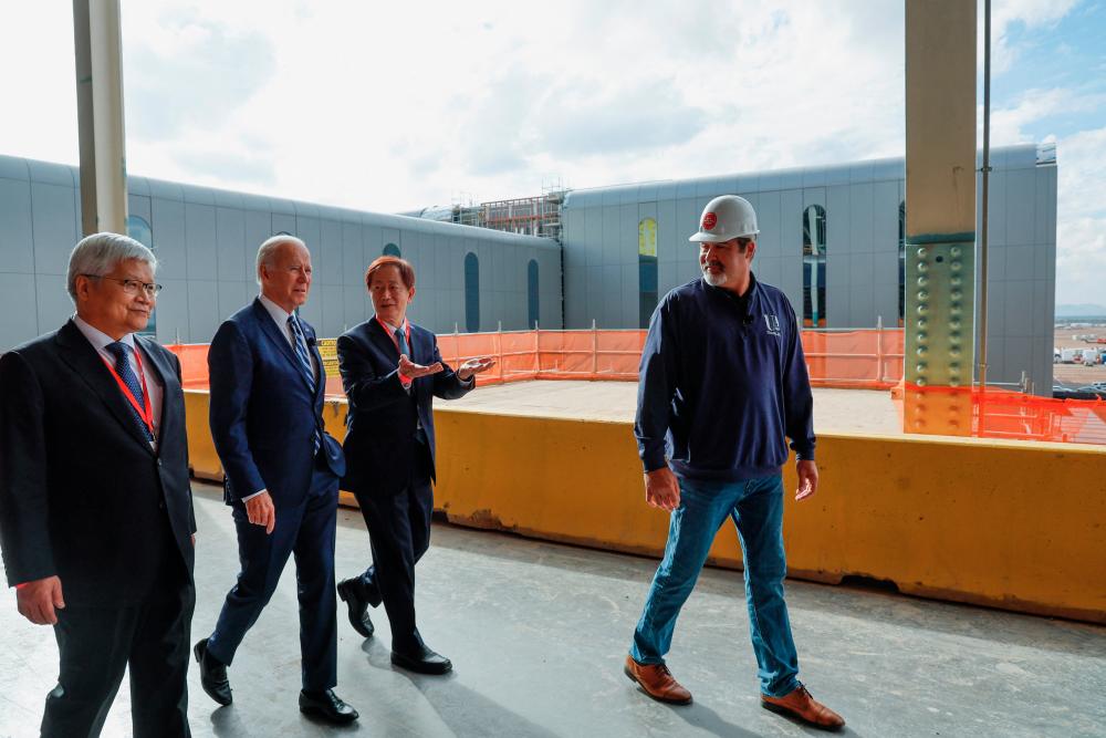 Biden walking with TSMC’s chief executive officer CC Wei and chairman Mark Liu during a visit to TSMC AZ’s first Fab (Semiconductor Fabrication Plant) in Phoenix on Tuesday. – Reuterspic