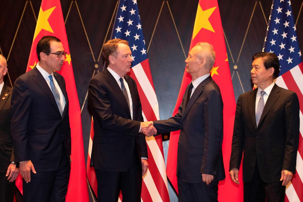 US Trade Representative Robert Lighthizer shakes hands with Chinese Vice Premier Liu He as US Treasury Secretary Steven Mnuchin and China's Commerce Minister Zhong Shan look on during a family photo at the Xijiao Conference Center in Shanghai, China, July 31, 2019. - Reuters