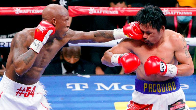 Yordenis Ugas (left) hits Manny Pacquiao in the sixth round of their WBA welterweight title fight at T-Mobile Arena on Sunday in Las Vegas, Nevada. – AFPPIX