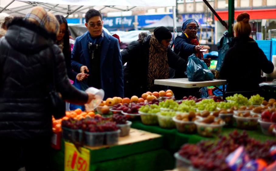 People shop to buy fruit and vegetables at a stall in Lewisham Market, south east London, Britain, March 9, 2023. REUTERSPIX