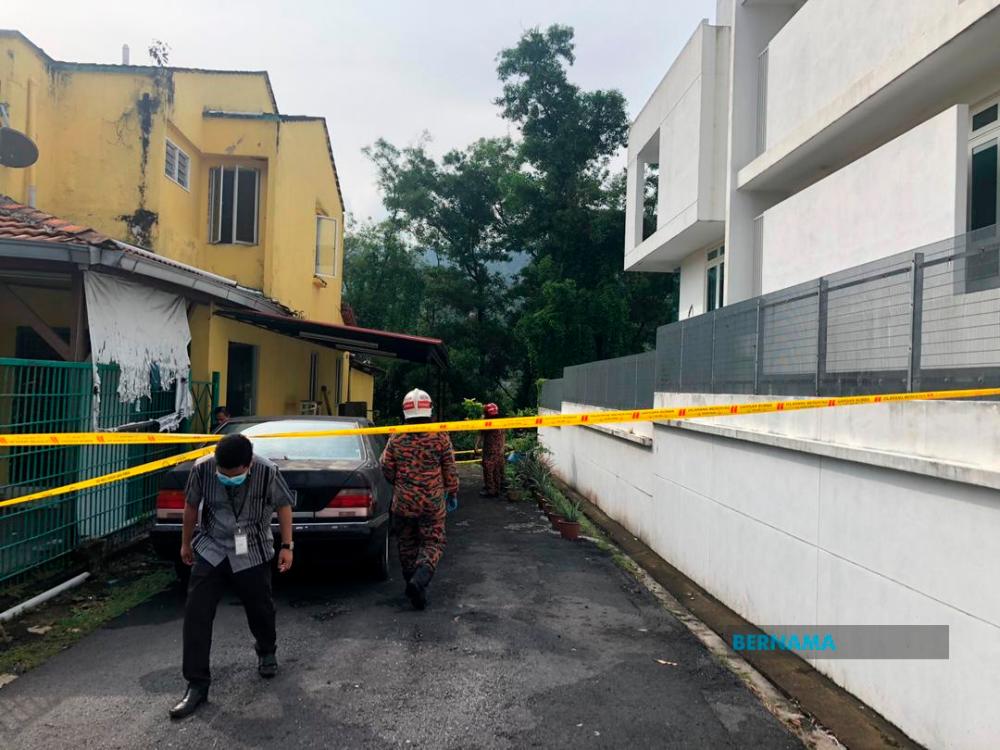 Officers from the Fire and Rescue Department at Taman Kelab Ukay, Bukit Antarabangsa following a landslide in the vicinity early today. — Bernama