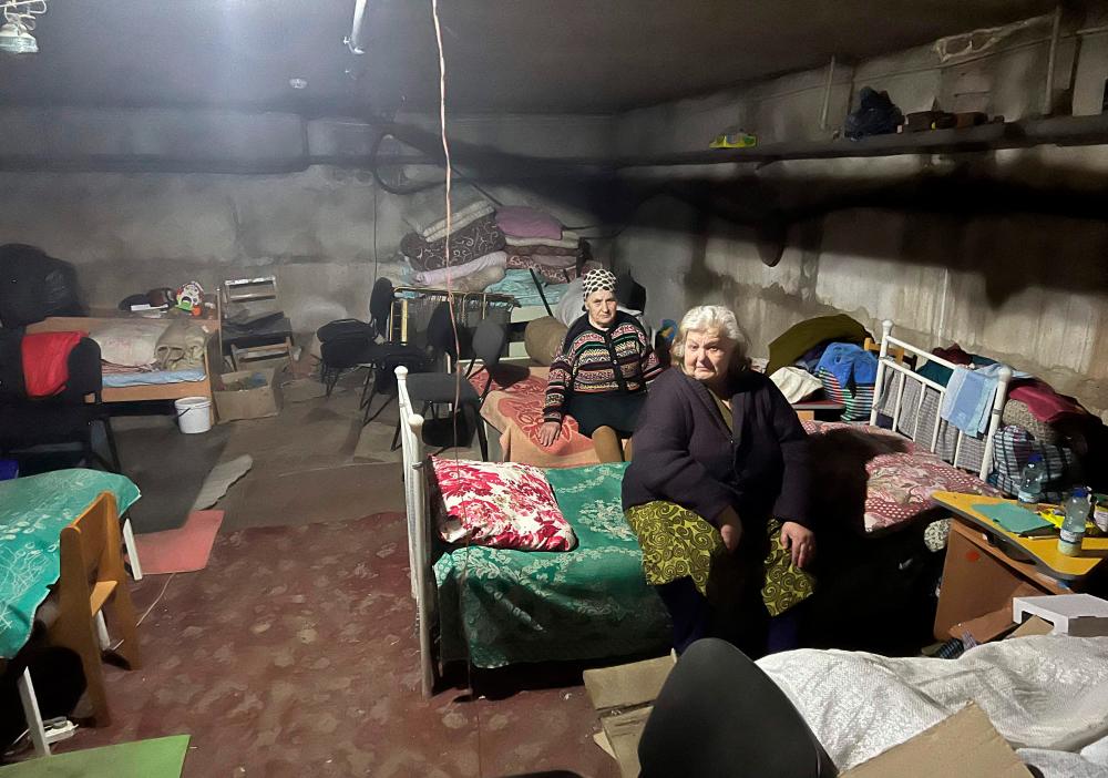 Elderly women sit on beds in a basement, as they hide from shelling , in the village of Kutuzivka, Kharkiv region, on May 27, 2022, amid the Russian invasion of Ukraine. AFPPIX