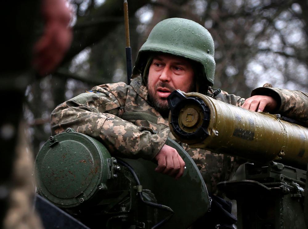 A Ukrainian soldier stands on an armoured personnel carrier (APC), not far from the front-line with Russian troops, in Izyum district, Kharkiv region on April 18, 2022, during the Russian invasion of Ukraine. AFPPIX