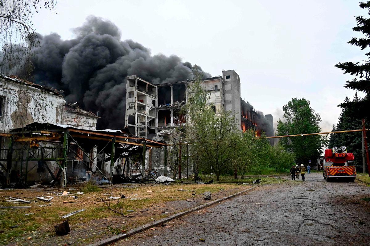 Firefighters extinguish a fire at a civilian plant following Russian powerful attacks to Ukrainian city of Kharkiv early on June 7, 2025. AFPPIX