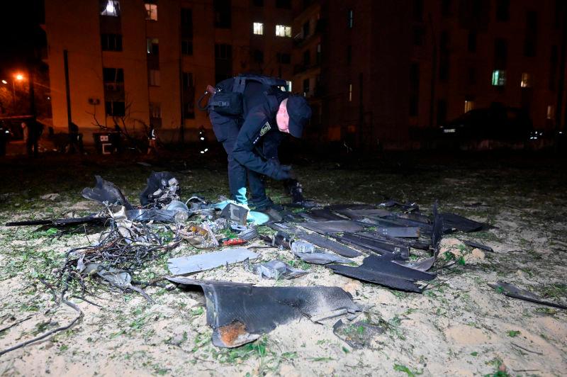 A police expert examines fragments after a drone strike on Kharkiv on May 3, 2025. AFPpix